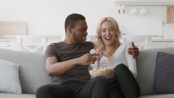 Couple Watching TV Together Eating Popcorn Having Fun At Home alt