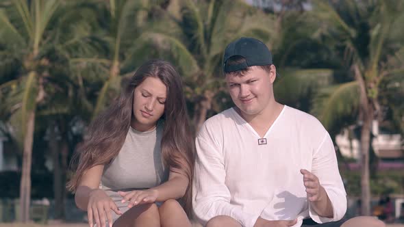 Pretty Lady with Long Hair Waved By Wind Talks To Guy alt