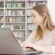 Charming Teen Girl Working on Her Computer at the Library - VideoHive Item for Sale