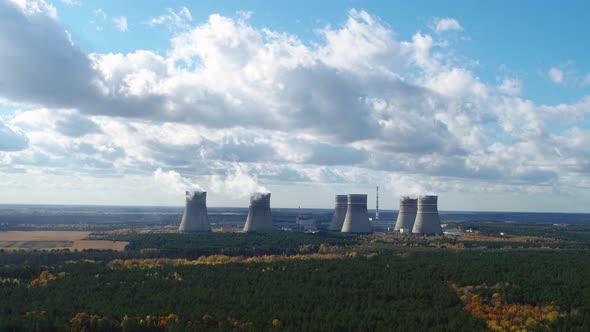 Cooling Towers of Nuclear Power Plant Against the Blue Cloudly Sky Aerial View alt