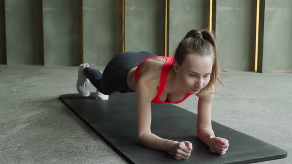 Young Sporty Woman Doing Leg and Buttocks Exercises alt