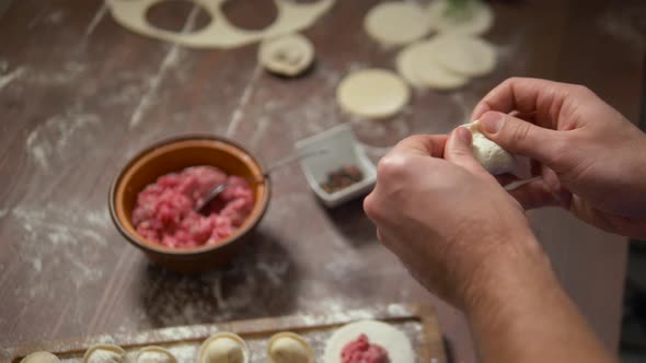 Male Hands Make Dumplings Close Up. Homemade Food.
