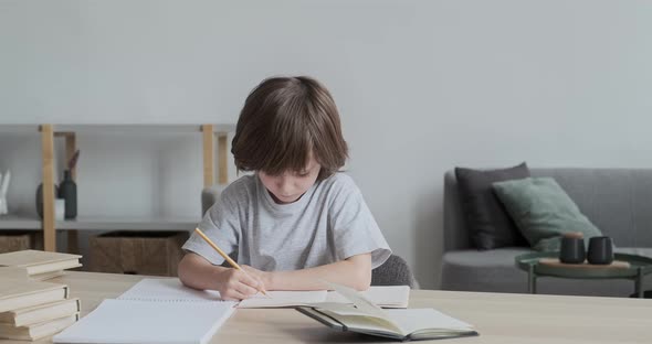 Thoughtful and Considerate Attentive and Hardworking 6Yearold Kid Learning to Write and Draw at Home alt