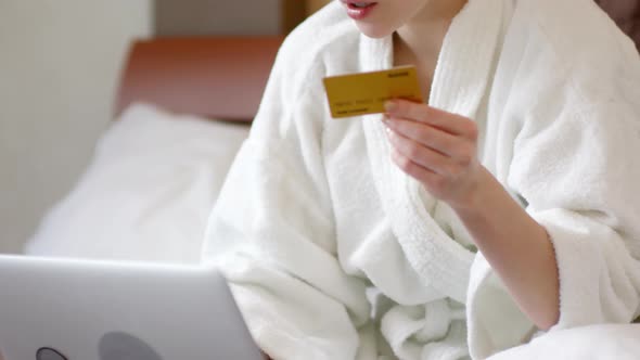 Woman with Towel on Head Doing Online Shopping at Home alt