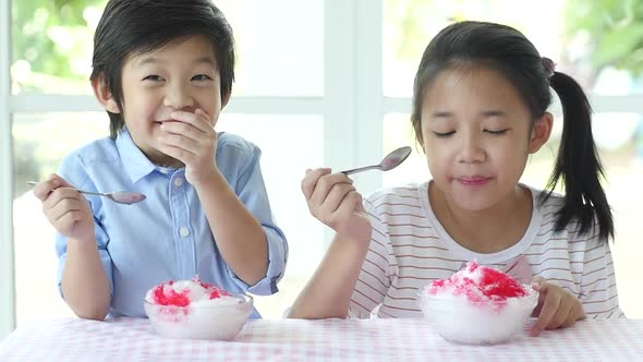 Happy Little Asian Children  Eating Ice Cream At Home alt