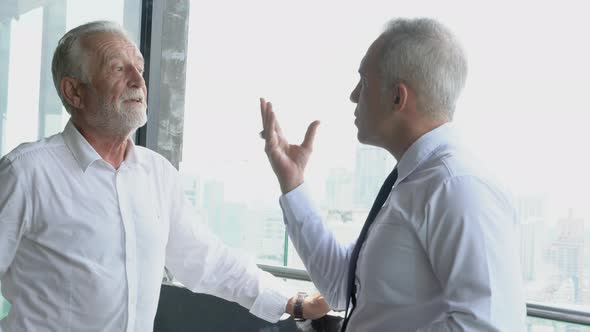 Two senior businessman discussion with partnership about work at office. alt