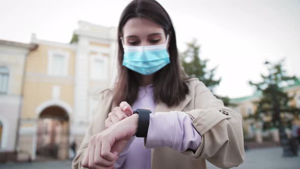 Young Tourist Woman Looking on Smart Watch Near Airport alt