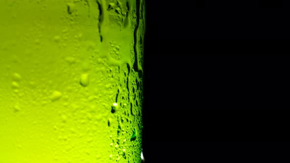 Water Drops Falling Down on the Glass of Beer