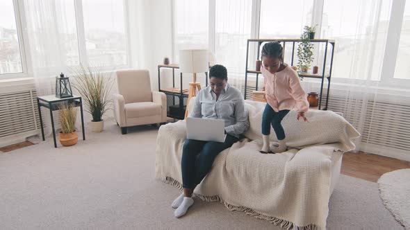 Afro Little Girl Daughter Kid Baby Noisy Child Jumping on Couch Having Fun Bad Behavior Interferes alt