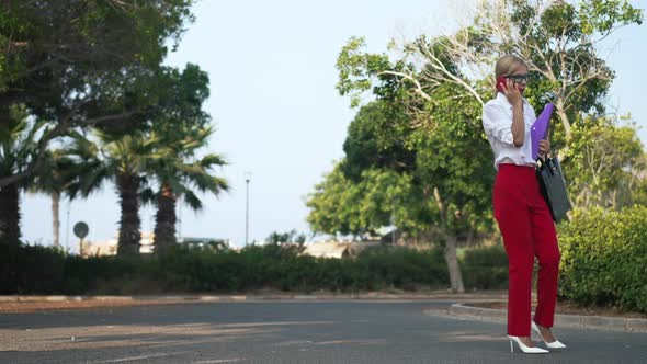 Anxious Worried Caucasian Woman Talking on Smartphone Walking From Side to Side in Slow Motion alt