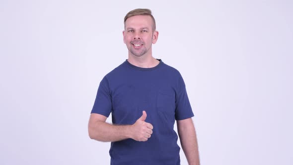 Portrait of Happy Blonde Man Giving Thumbs Up alt