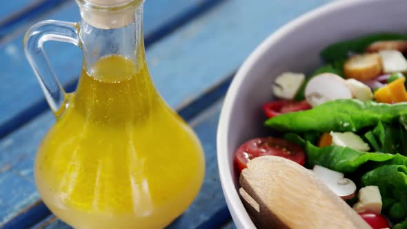 Salad with oil in bowl alt