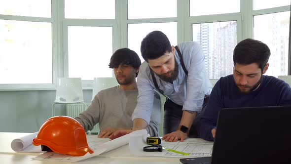 Architect Showing His Coworker Something on the Plans