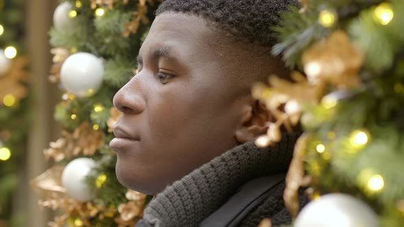 thoughtful young black man at christmas time lost in his thoughts alt