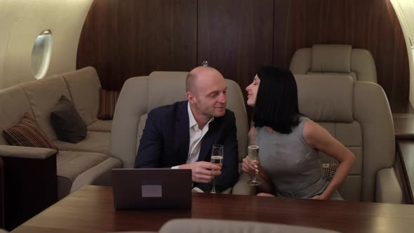 Young Couple Man Woman clink Glasses and Drink Champagne, Woman Kisses Young Man  alt