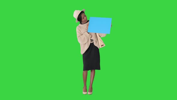 African American Woman Holding a Blank Placard on a Green Screen, Chroma Key alt