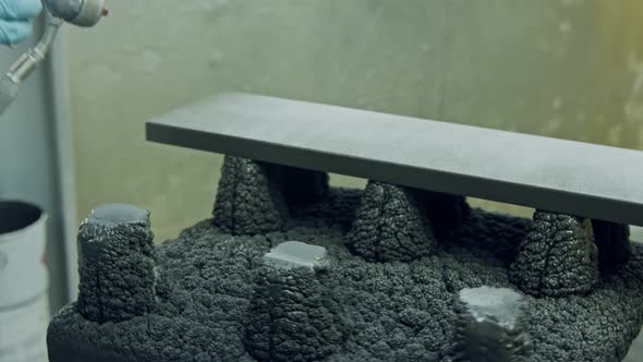 Slow motion of a worker painting kitchen wood doors using spray paint alt