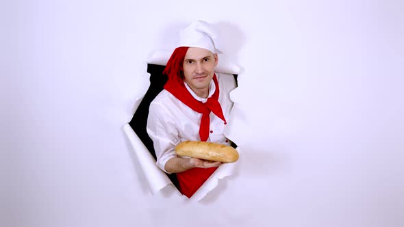 Young Man with Red Dreadlocks Dressed As Chef Holding White Bread alt