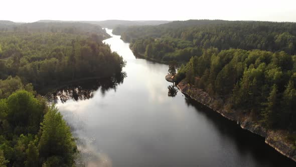 Stony banks and forested landscape around, aerial shot of Murolahti bay