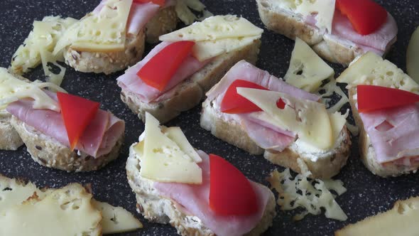 Cold appetizer. Cold cuts. Spicy food on black background. Different snacks 