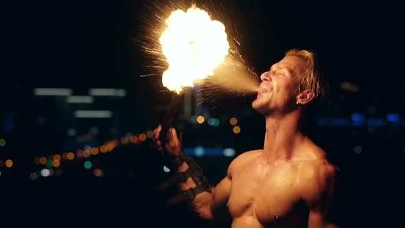 Young Blond Male Breathes Out Large Stream of Fire Making Fireball Slow Motion Closeup Shot alt