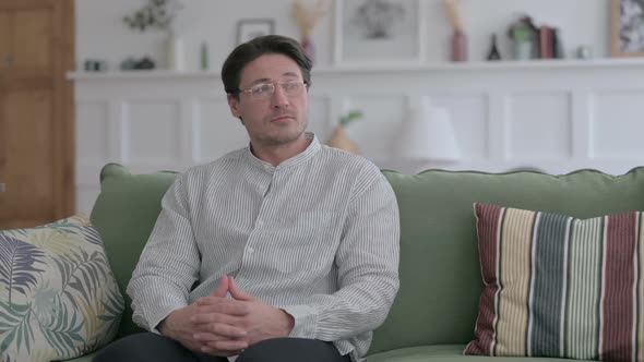 Relaxed Young Man Sitting on Sofa alt