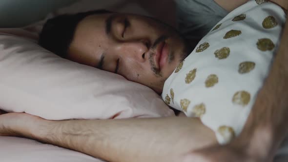 Close up of the Asian man sleeping in the bedroom at home.