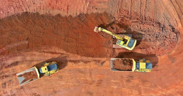 Top Aerial View Excavator Truck are Loading Soil a Dump Truck alt