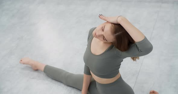 Yoga Trainer Performs Side Bends Sitting on a Twine Gymnastic Woman with Tight Body Curves Does alt