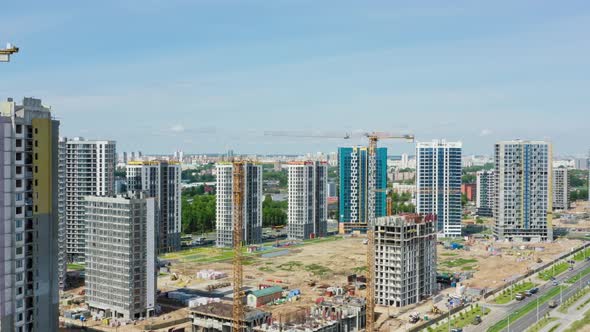 Aerial Top View Construction Site with Yellow Tower Cranes Working on Building Site in Big City alt