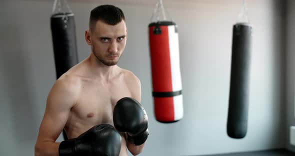 Steadicam Shot Portrait of the Kickboxer Standing in the Fighting Stance MMA Fighter is at the alt