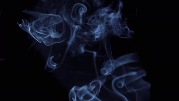 Real Silky Smoke Flowing On Black Background