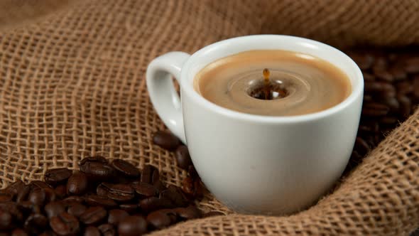 Drop Falling Into a Cup of Coffee in Super Slowmotion. alt