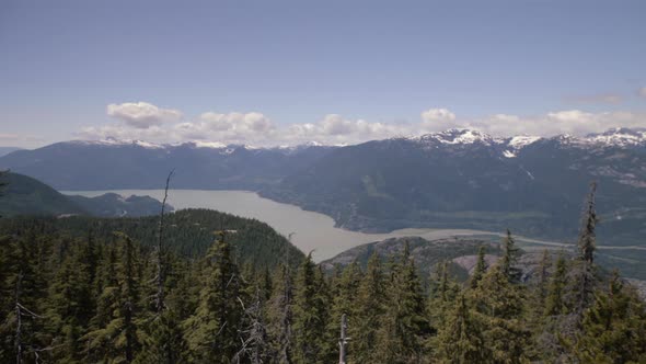Wide panorama shot of Howe sound on Spring sunny day, more forest in foreground alt