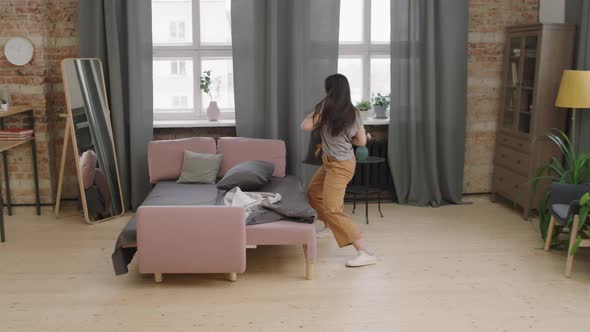 Young Woman Partying Alone at Home alt