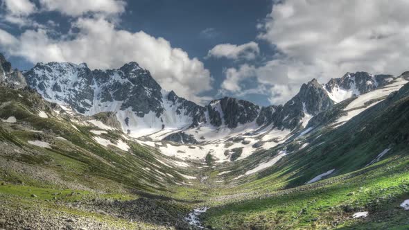 8K Glacial Valley and Alpine Meadow in Front of Rocky Mountain Peaks alt