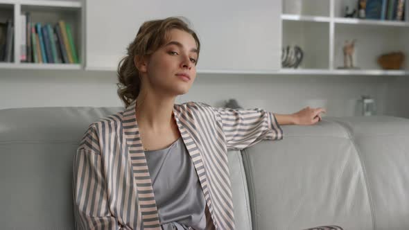 Serious Woman Thinking Sofa in Pajamas Closeup alt