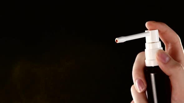 Spray Drops of Medicine on Black, Slow Motion, Close Up alt