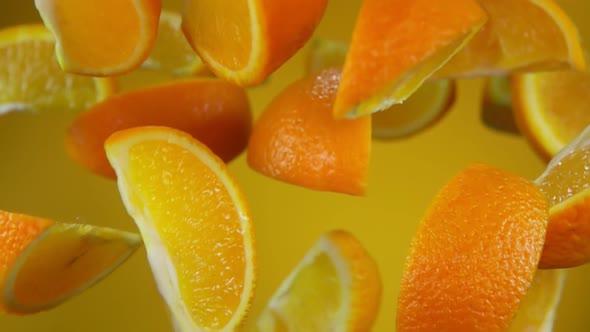 Juicy Slices of Orange Are Bouncing on the Yellow Background alt