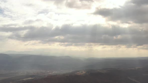 Rays of sun through the cloudy sky 4K drone video alt