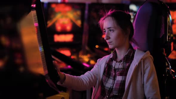 Woman Using Stick Joystick and Playing Flight Simulator Arcade Machine