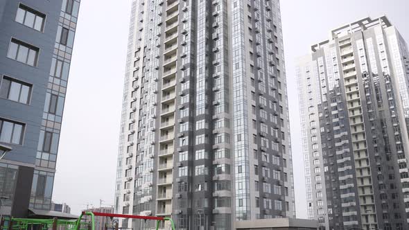 Food Delivery Man Riding Bike Among Skyscrapers alt