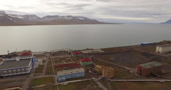 Drone Flight Over the Pipe Stretching By the Ground Along the Settlement of Barentsburg. Spitsbergen alt