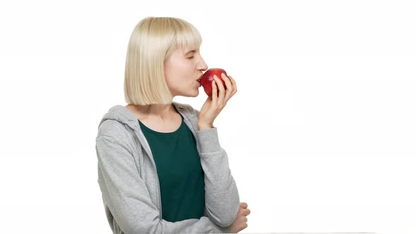 Portrait in Profile of Happy Woman 20s Wearing Casual Clothes Eating Red Juicy Apple Tasting alt