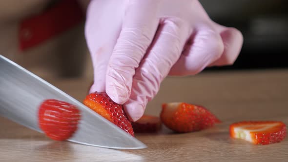 Chef Cook Cuts Strawberries on a Cutting Board alt