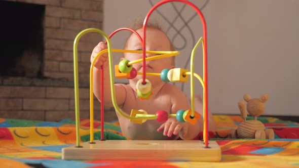 The baby develops fine motor skills. Montessori toy. Toddler playing with a Montessori toy.