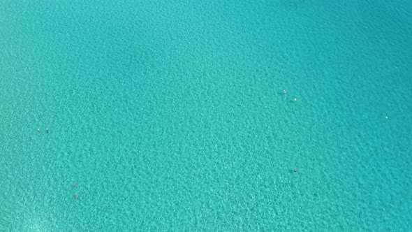 People relaxing in crystal clear turquoise blue water in Mediterranean alt