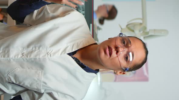 Vertical Video Stomatologist Doctor Talking on Web Cam with Patients alt