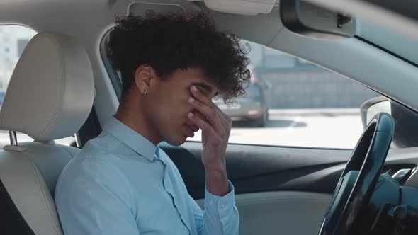 Young African American Sitting Inside Car is Very Upset and Stressed alt