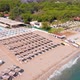 Flight Over the Beach with Umbrellas Towards the Pool in a Luxury Hotel - VideoHive Item for Sale